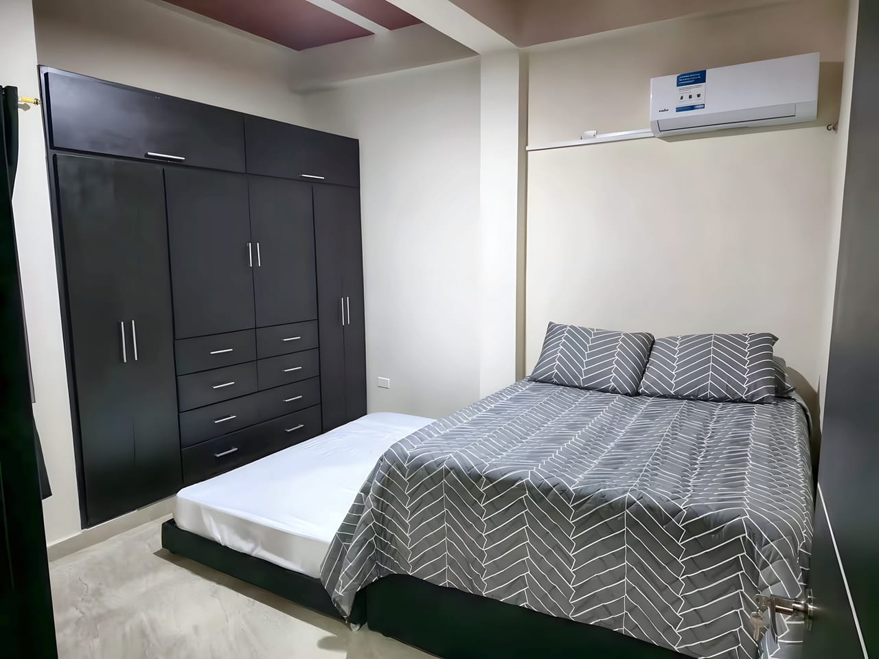Habitación con cama doble, clóset y aire acondicionado